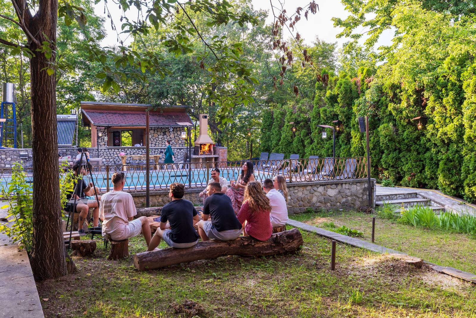 Grup de prieteni adunat în jurul fire-pit-ului la Casa Rodica Breaza